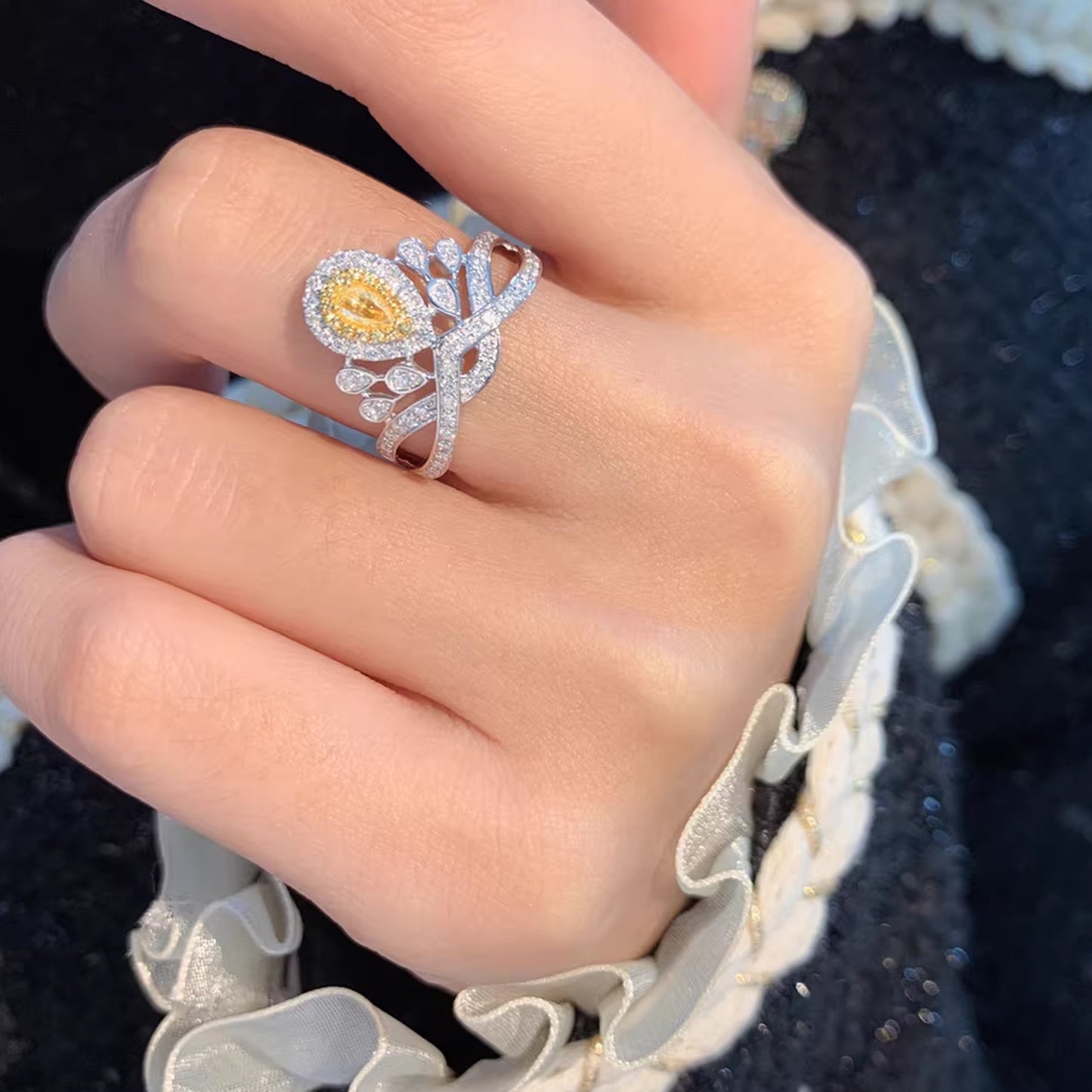 luxury yellow pear cut diamond halo ring with floral crown-inspired setting and pavé diamonds on white gold band